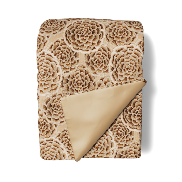 A silo image of the Astera Throw, part of the Judith Leiber Couture by Ann Gish collection, featuring beige and gold floral embroidered fabric. - THAAK‑GPU