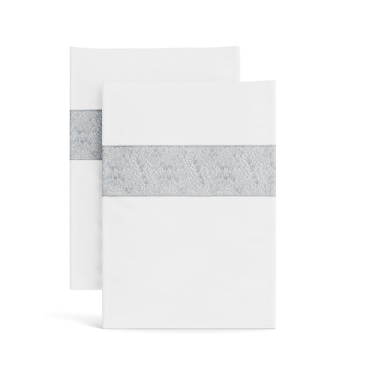 Stacked white Minaudiere pillowcases from the Judith Leiber Couture x Ann Gish collection, detailed with a silver sequined border band that echoes the jeweled Minaudiere motif. - PCMIK‑WHI‑SIL PCMIS‑WHI‑SIL