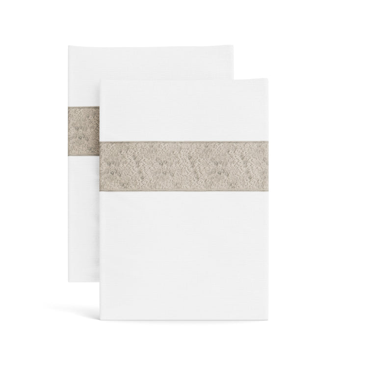Stacked white Minaudiere pillowcases from the Judith Leiber Couture x Ann Gish collection, detailed with a taupe sequined border band that echoes the jeweled Minaudiere motif. PCMIK‑WHI‑TAU PCMIS‑WHI‑TAU