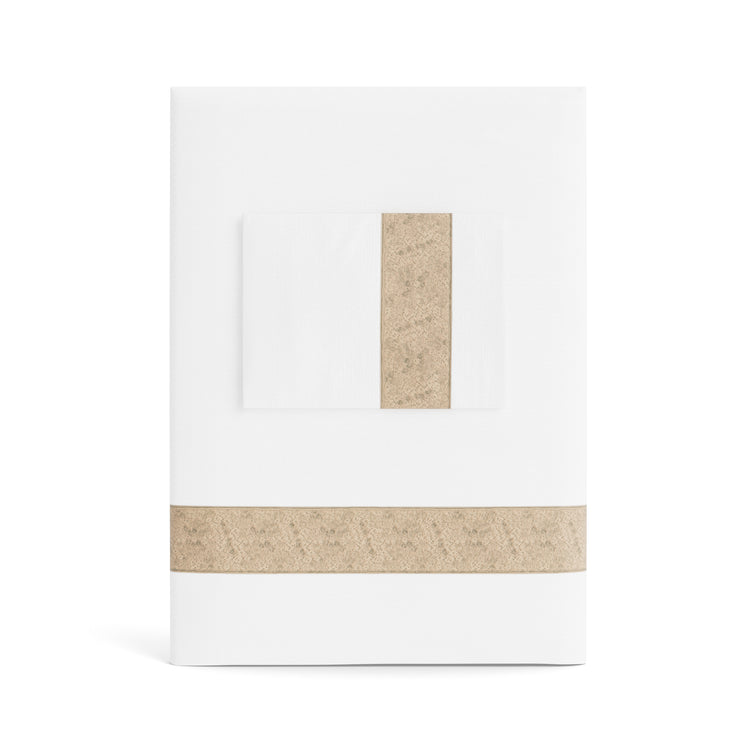 A folded white Minaudiere Sheet Set by Judith Leiber Couture x Ann Gish, shown with its matching pillowcase on top, featuring a sand sequenced border band that mirrors the jeweled sparkle of the Minaudiere design. - SSMIK-WHI-SAN SSMIQ-WHI-SAN