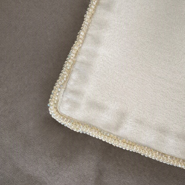 Close-up of a silver silk fabric corner with a decorative border of small iridescent pearls and clear rhinestones on top of metallic silk fabric. - SHMOE-MET-SIL SHMOK-MET-SIL SHMOS-MET-SIL PWMO3616-MET-SIL