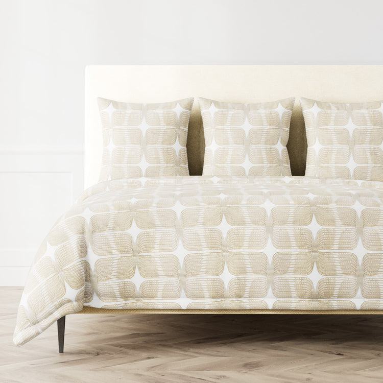A bed styled with the Ann Gish Puccini duvet cover and three 24